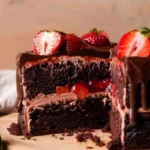 chocolate cake with chocolate strawberries topped with ganache